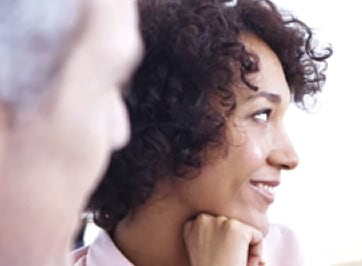 Close up of curly, black-haired woman smiling