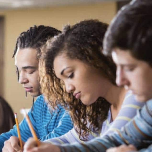 Three students writing