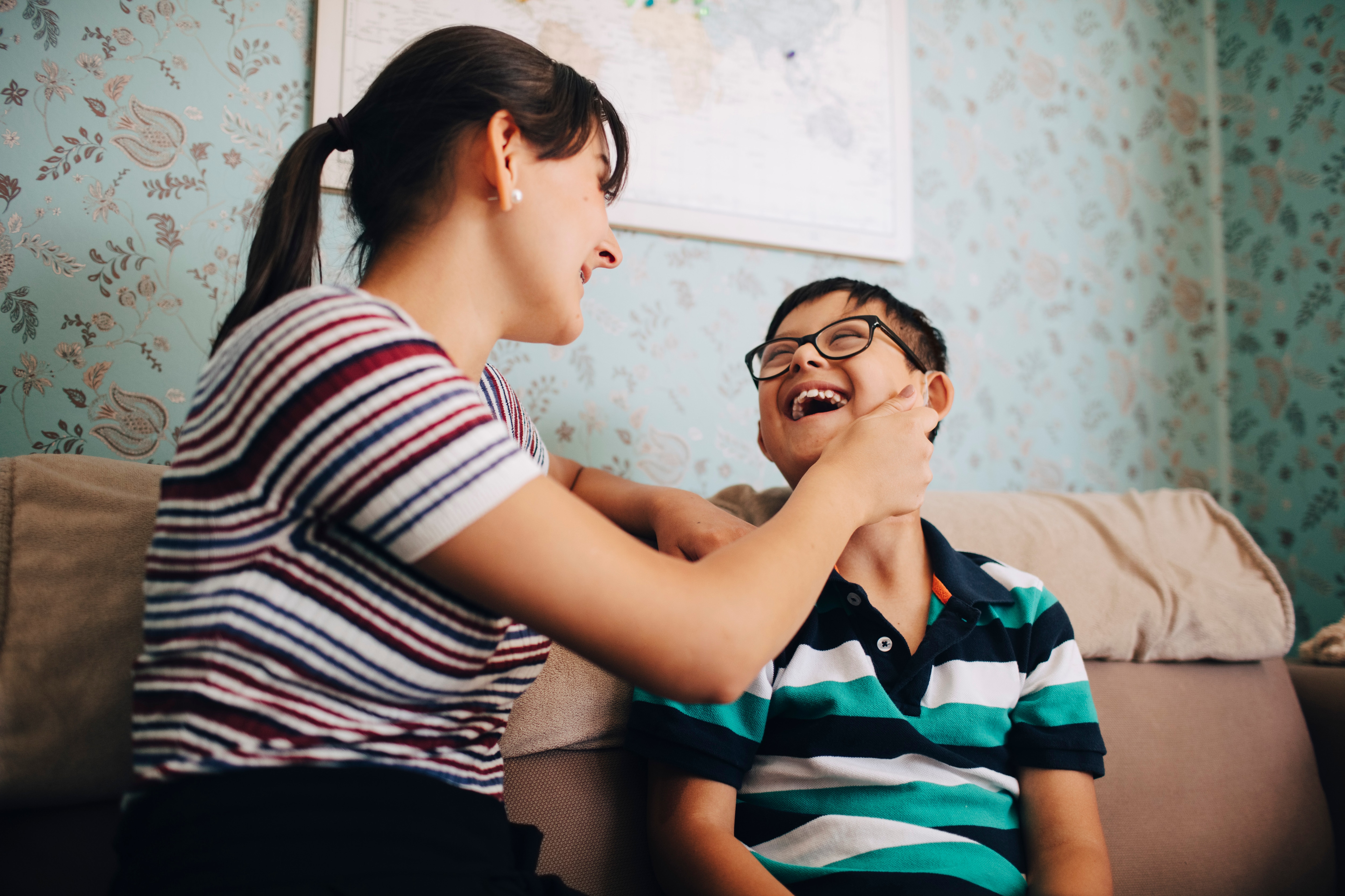 Image of mom and child laughing together while wearing striped short sleeve tops.