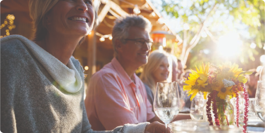 older people at a table with flowers
