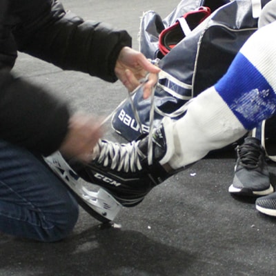 A hockey skate being laced up