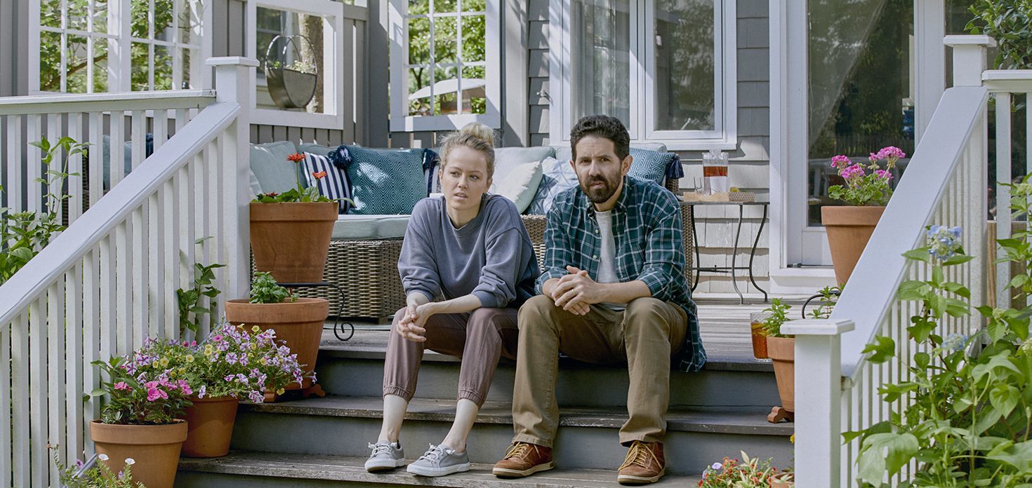 couple sitting on the step of their home