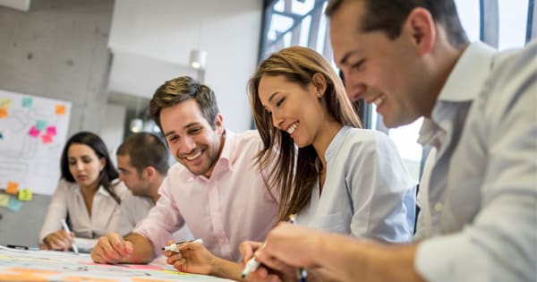 group of coworkers smiling at table